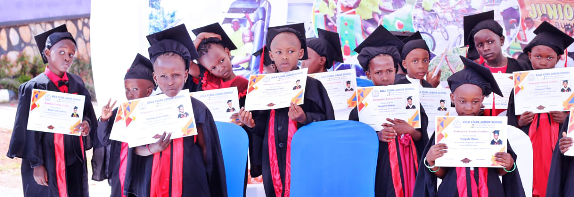 BoldStars Junior School preschool children proudly lining up in their graduation gowns, ready to celebrate their achievement.